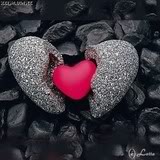 Broken stone heart with red heart inside.